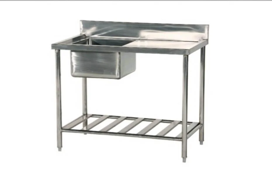 Undercounter dishwasher installed beside a stainless steel sink table